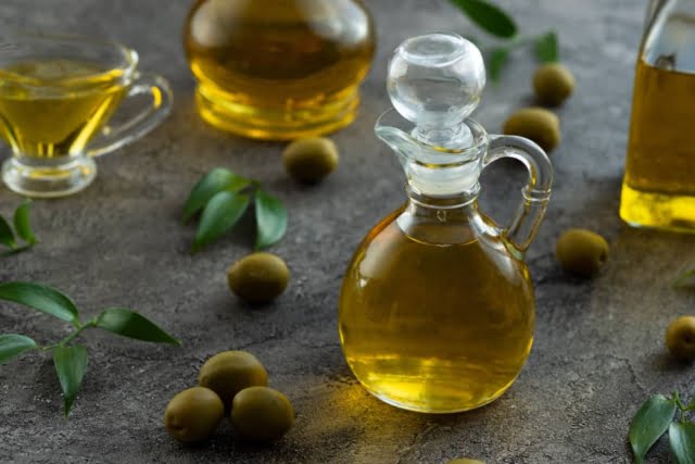 high view bottles filled with olive oil marble background